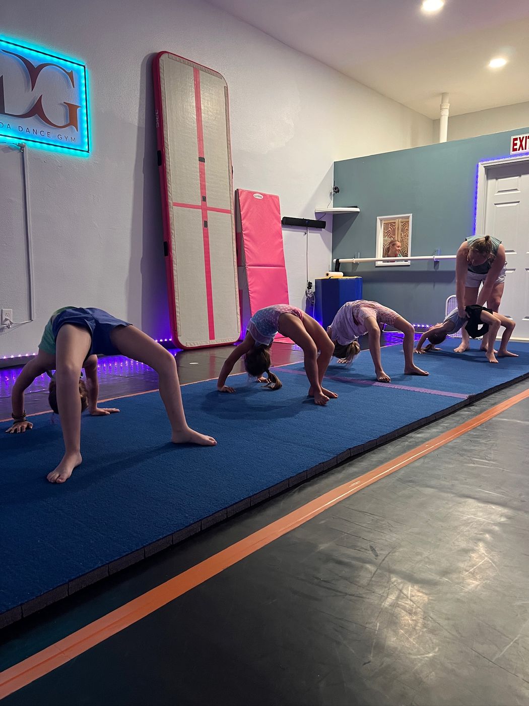 Florida Dance Gym students practicing acro bridge skills in class