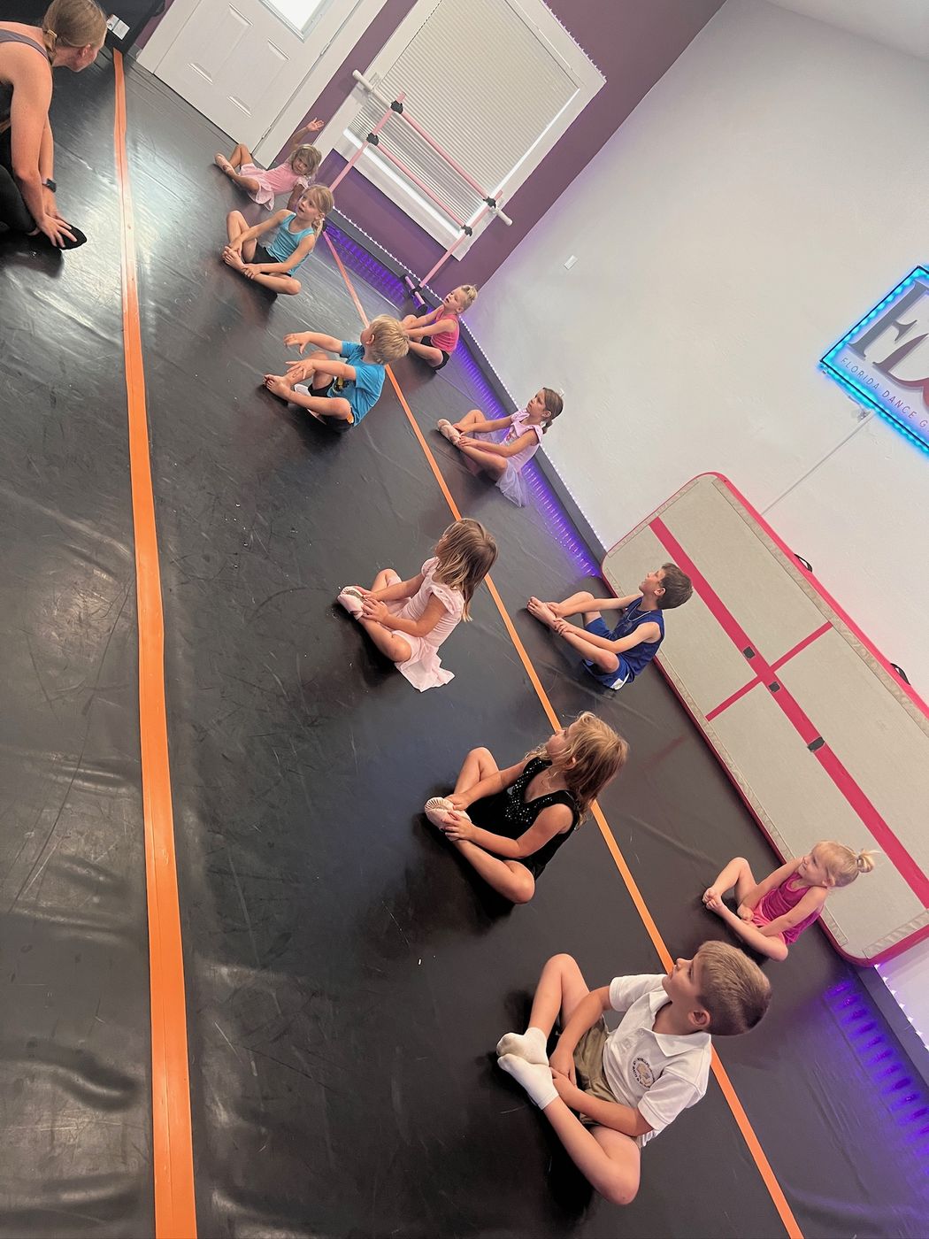 Florida Dance Gym students stretching together during class