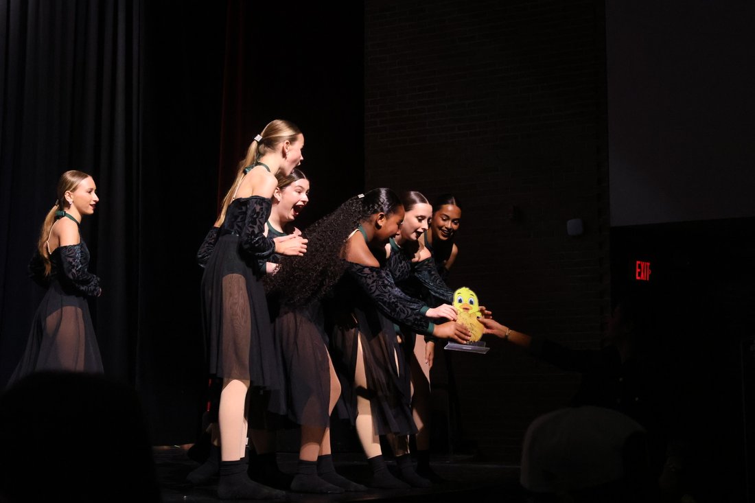 Florida Dance Gym team celebrating an award onstage